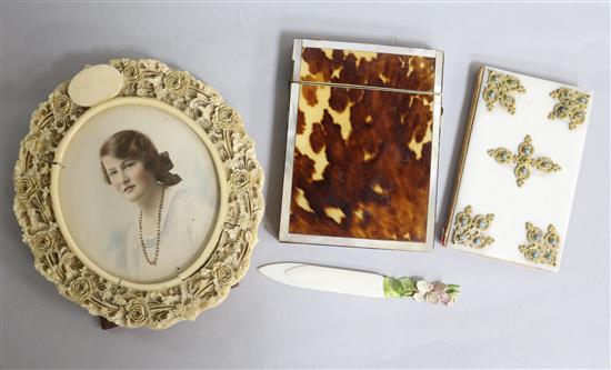 A carved ivory circular frame, an ivory page marker, a French aide memoir and a tortoiseshell card case